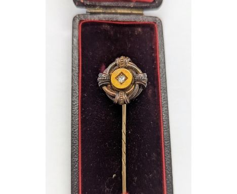 A late 19th/early 20th century yellow metal oval tie pin inset with central diamond, cased Location: Cab 