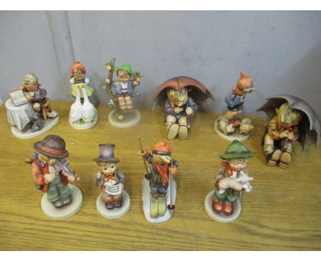 Ten Hummel figures to include two figures of boys holding umbrellas 