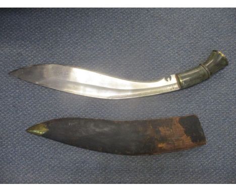 A 19th century Nepalese kukri with horn handle having brass pommel cap with scrolled floral decoration, leather scabbard with