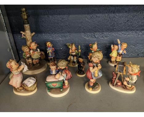 Ten Hummel figures to include a table lamp in the form of a tree with two figures 