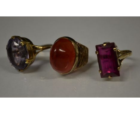 Rings - a red Chalcedony irregular cabochon dress ring, textured 9ct gold shank, size L. stamped 9ct, 9.8g;  an Amethyst oval