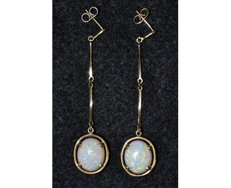 A pair of 9ct gold opal doublet drop earrings, each with a single oval white opal doublet, flashing green blue and orange col