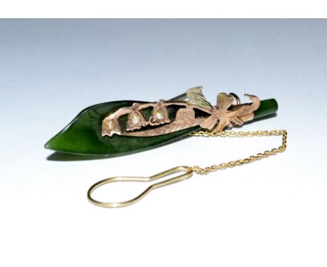 A jade green stone 'Kukri' brooch, jade blade, mounted within a gold surround inset with three seed pearls, stamped 9ct, 50mm