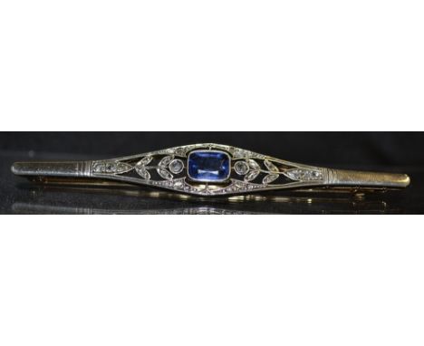 An Edwardian diamond and sapphire paste brooch, central blue paste sapphire effect baguette, open floral surround encrusted w