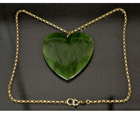 A large Jade green stone heart shaped pendant, suspended from a 9ct gold chain, stamped 375, 44cm long,  33.5g gross