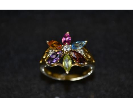 A multi stone flower head ring, open floral crown inset with thirteen assorted diamonds and other coloured stones including, 