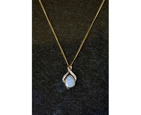 An opal doublet pendant, teardrop opal doublet, ribbon surround, inset with seven white sapphire accents, 9ct gold mount, sta