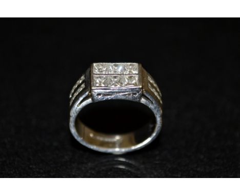 A diamond cluster ring, rectangular platform set with six princess cut diamonds, each approx 0.15ct, between diamond inset tw