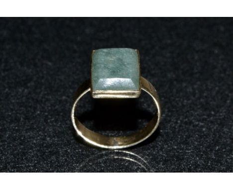 A Jade green stone panel ring, rectangular table cut panel, 14ct gold shank, stamped 14K, size T, 4.8g gross