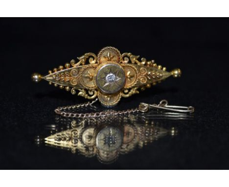 A Victorian diamond aesthetic movement brooch, central star set round cut diamond, approx 0.12ct, above a shaped filigree and