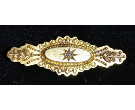 A Victorian diamond aesthetic movement brooch, central star set diamond accent, within an oval crest, and shaped floral surro