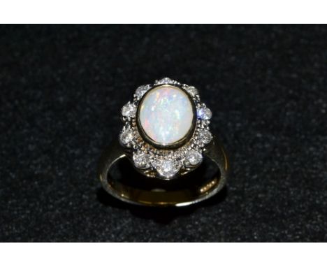 An opal and diamond cluster ring, central oval opal surrounded by a band of ten diamonds, 9ct gold shank, size O, 6.1g gross