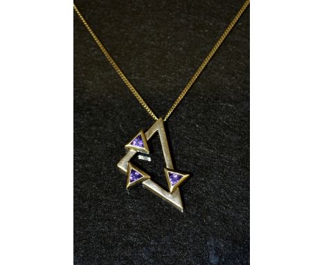 A modern triangular pendant, open body mounted to each side with a single triangular amethyst, stamped 9k 375, suspended from