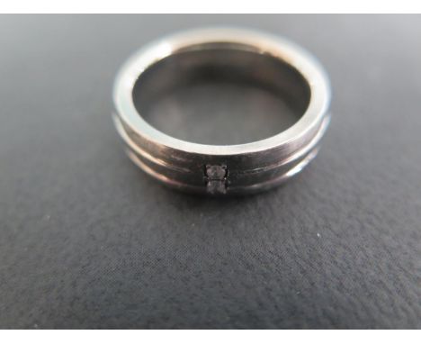A Titanium and Diamond Ring, Size R-S, approx 3.8 grams, two small diamonds set to outer band - in fair condition with light 