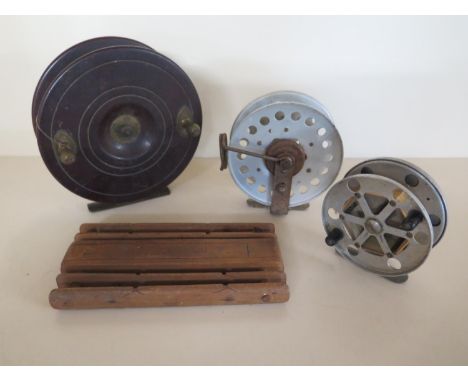 Three vintage fishing reels and a winder - largest reel 15cm diameter 
