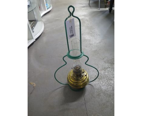 An LNER hanging railway oil lamp, brass reservoir within steel housing, glass chimney to top 