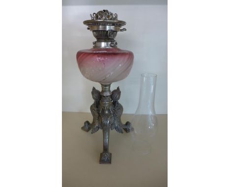 A Victorian silver plated sphinx base oil lamp, cranberry glass reservoir - small hairline crack in top - Hinks burner and gl