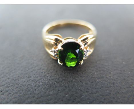 An 18ct yellow gold chrome diopside and diamond ring, size N, approx 4.2 grams - light usage wear 