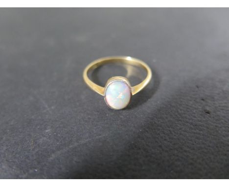 An 18ct Opal ring, size P, approx 2grams, opal 8mm x 6mm, marked 18ct - generally good 