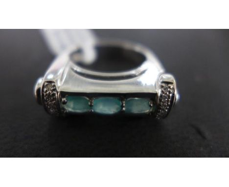 A white 9ct gold ring of unusual shape, three tourmalines to shoulder flanked by twelve small diamonds - light surface scratc