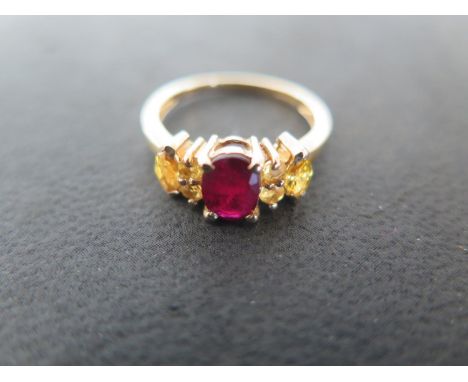 A 9ct yellow gold ruby and yellow sapphire ring, size N, approx 2.4 grams - light usage wear 