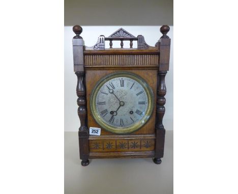 An 8 Day Oak Cased Bracket Clock, striking on a gong with a silvered dial, standing 39cm high, working in saleroom but no key