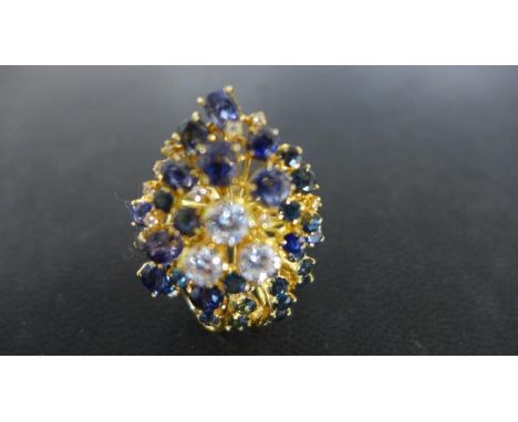 An 18ct yellow gold diamond and sapphire cocktail ring, size M-N, approx 12.6 grams, three central diamonds, sizes approx 0.5