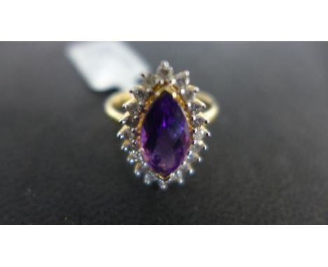 A Zambian amethyst and diamond 18ct yellow gold ring, the marquise cut amethyst surrounded by 20 small diamonds, size 0, appr