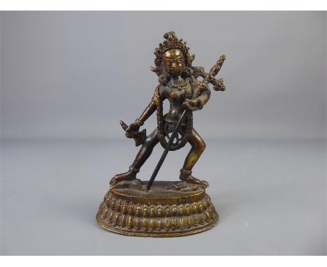 A Late 19th Century Tibetan Statue of The Dakini Vajrayogin, clasping a staff and draped with a decorative sash depicting sku
