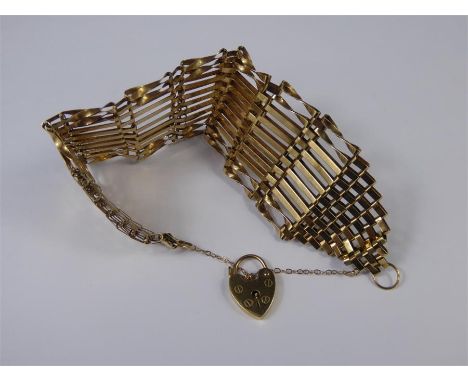A Lady's 9ct Yellow Gold Ten Bar Gate Bracelet, with heart-shaped clasp, approx 19.5 gms.
