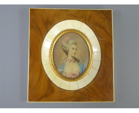 An Oval Portrait Miniature, a young woman, signed Loris to middle right, approx 5.5 x 7 cms, presented in a walnut and bone f
