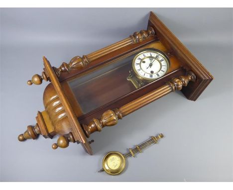 A German Wall Clock, the case measures approx 60 x 38 cms. Clock face diameter approx 28 cms.