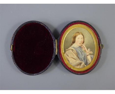 A 19th Century Oval Portrait Miniature, a titian-haired woman, approx 5 x 6 cms, presented in a maroon travelling case.