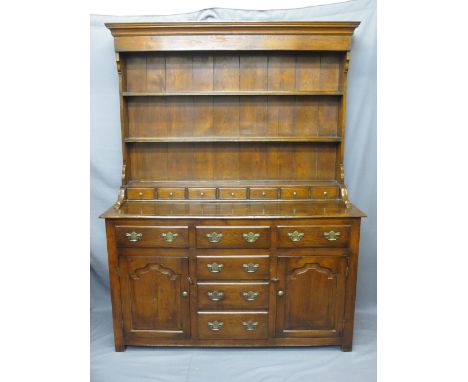 QUALITY REPRODUCTION OAK NORTH WALES TYPE DRESSER having a three shelf rack with seven spice drawers under, the base with a T