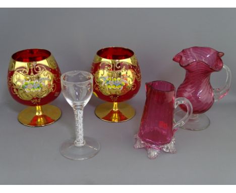 EARLY AIR TWIST STEM DRINKING GLASS, two cranberry jugs and a pair of Italian ruby and gilt brandy glasses