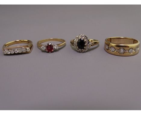 FOUR 9CT GOLD DIAMOND &amp; SEMI-PRECIOUS STONE SET DRESS RINGS to include a wide band diamond set ring, mid T-U, a raised di