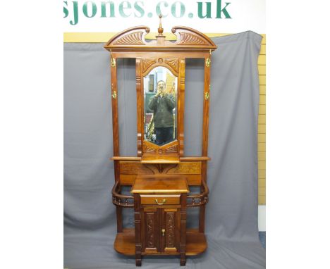 REPRODUCTION MAHOGANY HALL STAND, mirrored centre with brass hooks and shelf above a single central drawer with cupboard door