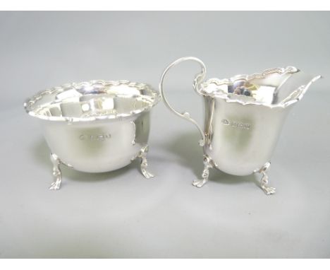 BIRMINGHAM SILVER CREAM JUG &amp; SUGAR BASIN dated 1935/6, makers Adie Brothers, castellated rims and raised on three hoof f