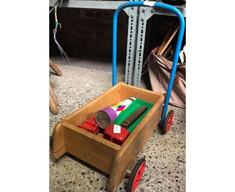 CHILD'S WOODEN 4 WHEELED PUSH CART WITH A KALEIDOSCOPE, HARMONICA, PLASTIC TRUCK &amp; WOODEN CAR