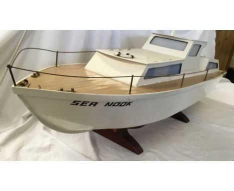 WHITE MODEL BOAT ON A STAND CALLED SEA NOOK