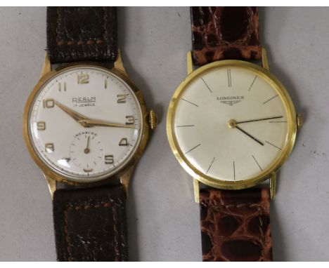 A gentleman's 18ct gold Longines manual wind wrist watch and a yellow metal Realm wrist watch.