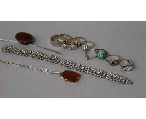 Ten assorted silver dress rings, a pendant, intaglio stick pin and a silver bracelet.