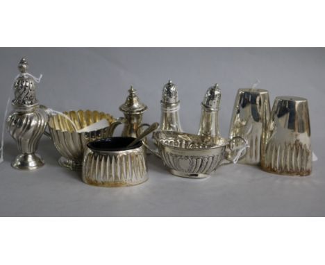 A small silver fluted cream jug and various silver condiments, including a William Hutton & Sons three-piece set with spoon o