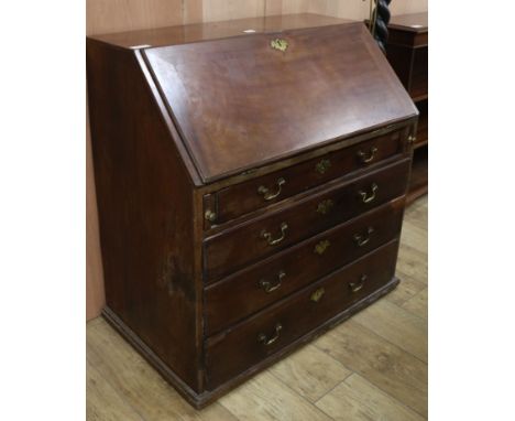 A George III mahogany bureau and an oak lamp standard W.95cm
