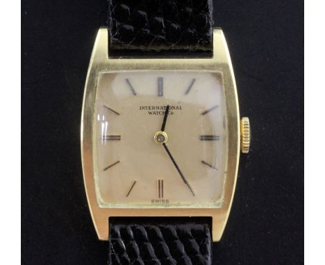 A lady's 18ct gold International Watch Co manual wind wrist watch, with tonneau shaped case and baton numerals, on associated