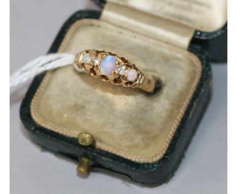 An early 20th century 18ct gold, white opal and diamond half hoop ring, size K.