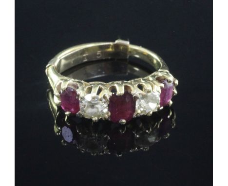 A gold and graduated five stone ruby and diamond set half hoop ring, set with oval, emerald and round cut stones, size K.