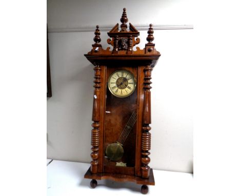 An Edwardian Vienna style wall clock with brass and painted dial, pendulum and key. 