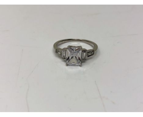 An Art Deco style emerald cut sterling silver ring, size N.