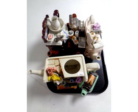 A tray containing four novelty teapots, one with sugar basin in the form of a toaster  